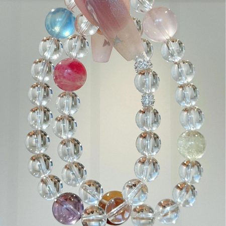 A natural 8mm white crystal bracelet with amethyst, rose quartz, and other crystal accessories